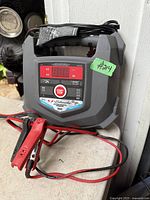 Front view of Schumacher digital battery charger with clamps and cables