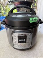 Front view of stainless steel Instant Pot showing control panel, lid and exterior condition
