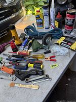 Overall lot layout showing majority of tools, extension cord, lubricants, caulk and ropes