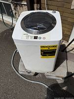 Front and top view of Giantex portable washing machine with EnergyGuide label and hoses