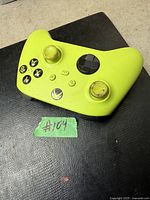 Top view of yellow Xbox wireless controller showing buttons and overall wear