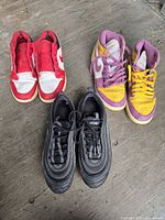 All three pairs of Nike sneakers displayed on floor