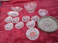All thirteen crystal pieces arranged on red cloth