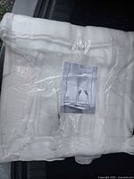 Foam-wrapped package containing mirrors with reference photo