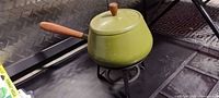 Green enamel fondue pot with lid on stand