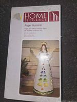 Front of boxed Home Elegance LED ceramic angel