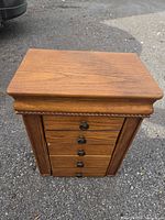 Front view closed showing wood finish and five drawers