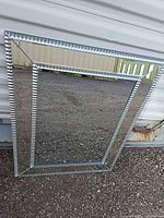 Front view showing mirrored tile frame and central mirror