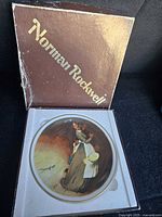 Front view of “The Snake Escapes” plate inside original Norman Rockwell box