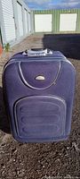 Front view of dark blue ORMI suitcase showing overall condition, front pocket and carry handle
