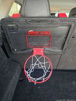 Front view showing clear backboard, red rim and net