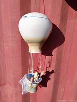 Full view hanging porcelain balloon with basket and figure