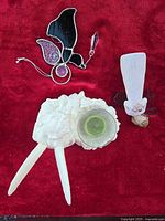 Group shot of three angel items on red cloth