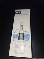 Front of boxed ABOX portable oral irrigator showing product image and key icons