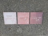 Fronts of three MDF squares showing printed designs