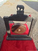Front view of gong on wooden frame