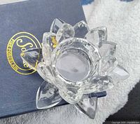 Lotus-shaped crystal tealight holder on Sorelle box