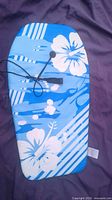 Top view of blue floral bodyboard with leash