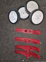 group of four wheels and four skis laid out on ground