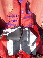 Wetsuit folded beside life jacket showing overall appearance
