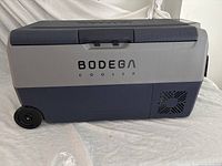 Side exterior view showing BODEGA logo, wheels and handle
