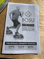 Trilingual owner's manual page for the BOSU Balance Trainer Sport 50 cm showing model and usage illustration