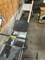 Side view of assembled rowing trainer showing rails, seat and frame