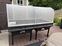 Front right angled view of assembled planter on stand with mesh canopy in place