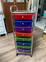 Full view of chrome rolling cart showing eight colour drawers and casters