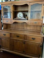 Full view of hutch showing upper glass doors, open shelf, drawers and lower cabinets