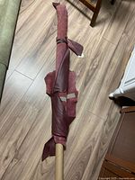 Full view of rolled burgundy faux leather on floor