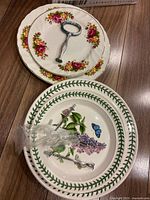 Stack showing two Old Country Roses plates, two Botanic Garden plates, and metal handle parts