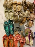 Group shot showing all twelve pairs of shoes laid out on floor