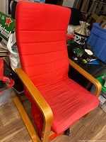 Full view of armchair showing bentwood frame and red cushion
