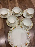Full set of teacups, saucers and plates on floor