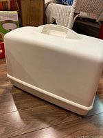 Full view of sewing machine case closed showing handle and overall shape