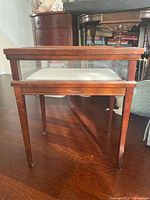 Side view of wooden glass display table