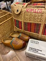 Group shot showing straw tote, wicker rack corner, wooden clogs, Stow n More box