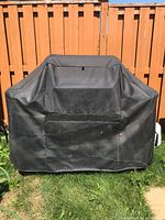 Grill covered with black fabric cover
