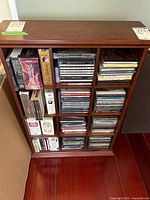 Cabinet filled with numerous CD jewel cases and box sets