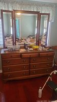 Full view of dresser with tri-fold mirror and contents atop for scale