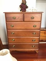 Front view showing six drawers and brass-tone pulls