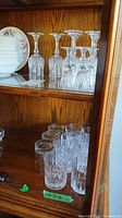 Cabinet shelf with crystal stemware and tumblers