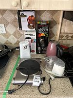 Group of countertop appliances and boxed slicer