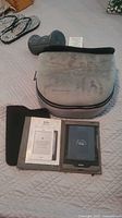 Overview showing Kobo eReader in case with booklet, Homedics foot massager cushion, foot roller