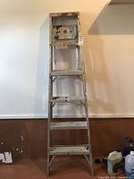 Full view of 6-ft aluminum step ladder standing upright