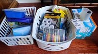 Three baskets containing assorted hardware supplies and consumables