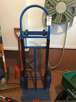 Front view of blue hand truck standing upright
