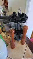Spice carousel, stainless milk holders, wood mills grouped