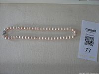 Full view of freshwater pearl necklace laid flat
